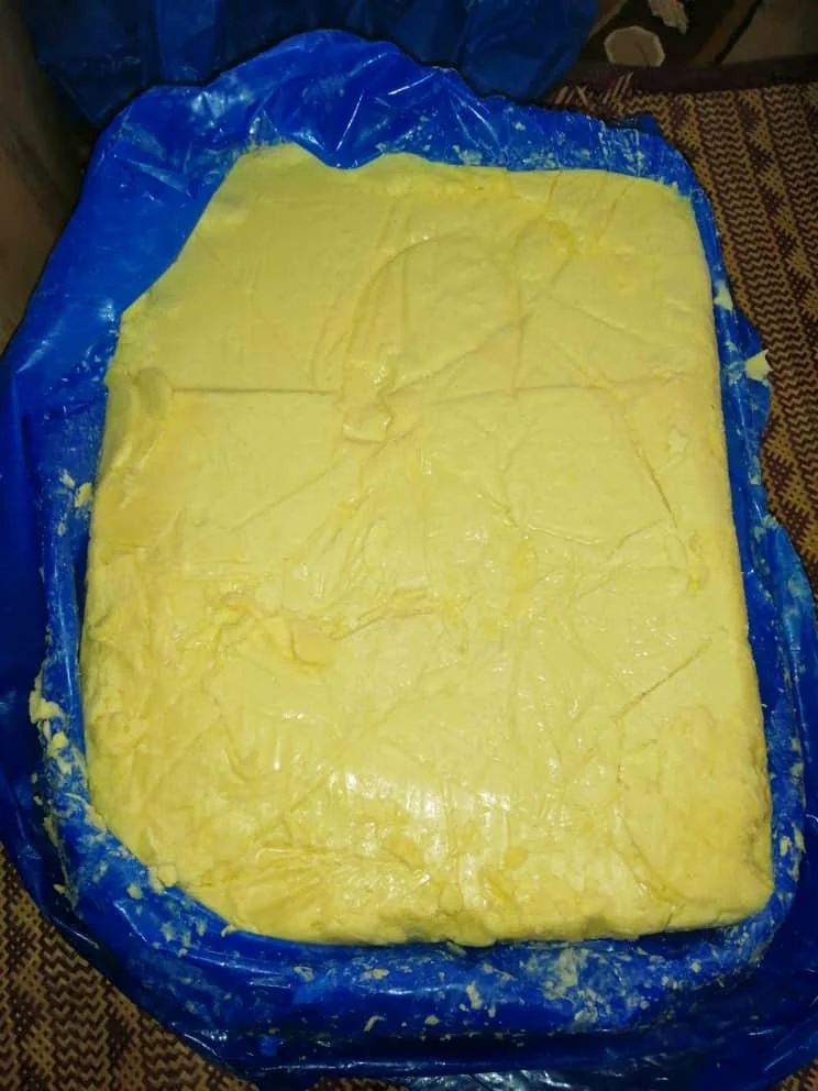 Fresh pale-yellow natural butter prepared in a lined container